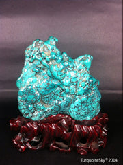 Natural blue turquoise stone with redwood stand 221.6 grams