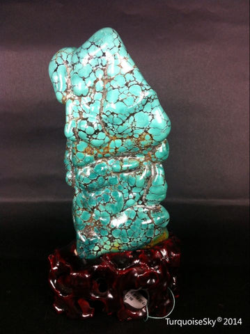Natural blue turquoise stone with redwood stand 226.2 grams