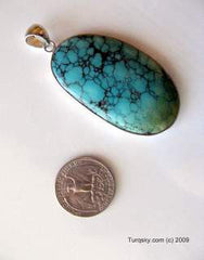 Oblong Natural turquoise pendant embeded in silver base 18.4 grams